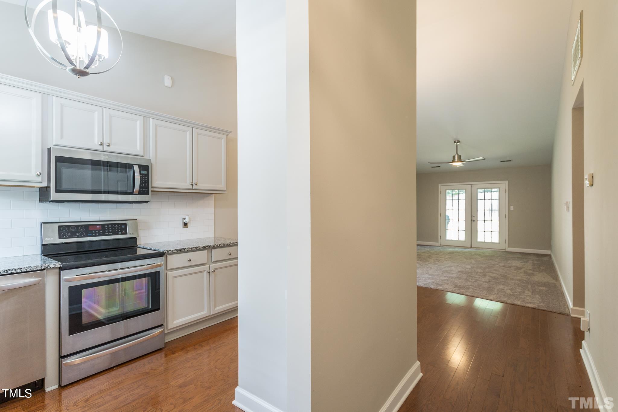 4424 Roller Court Raleigh, NC 27604 - Photo 6 of 19 a kitchen with stainless steel appliances a stove microwave and cabinets