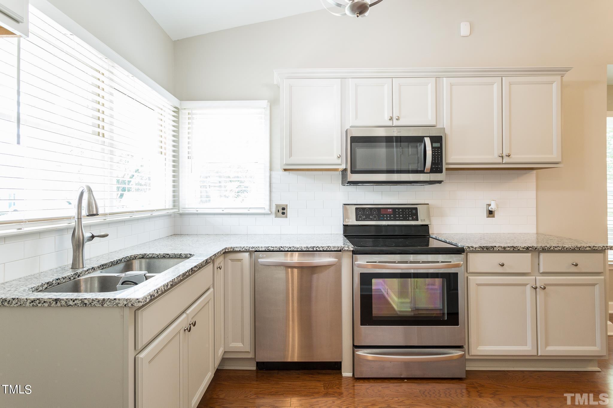 4424 Roller Court Raleigh, NC 27604 - Photo 8 of 19 a kitchen with granite countertop a sink and steel appliances