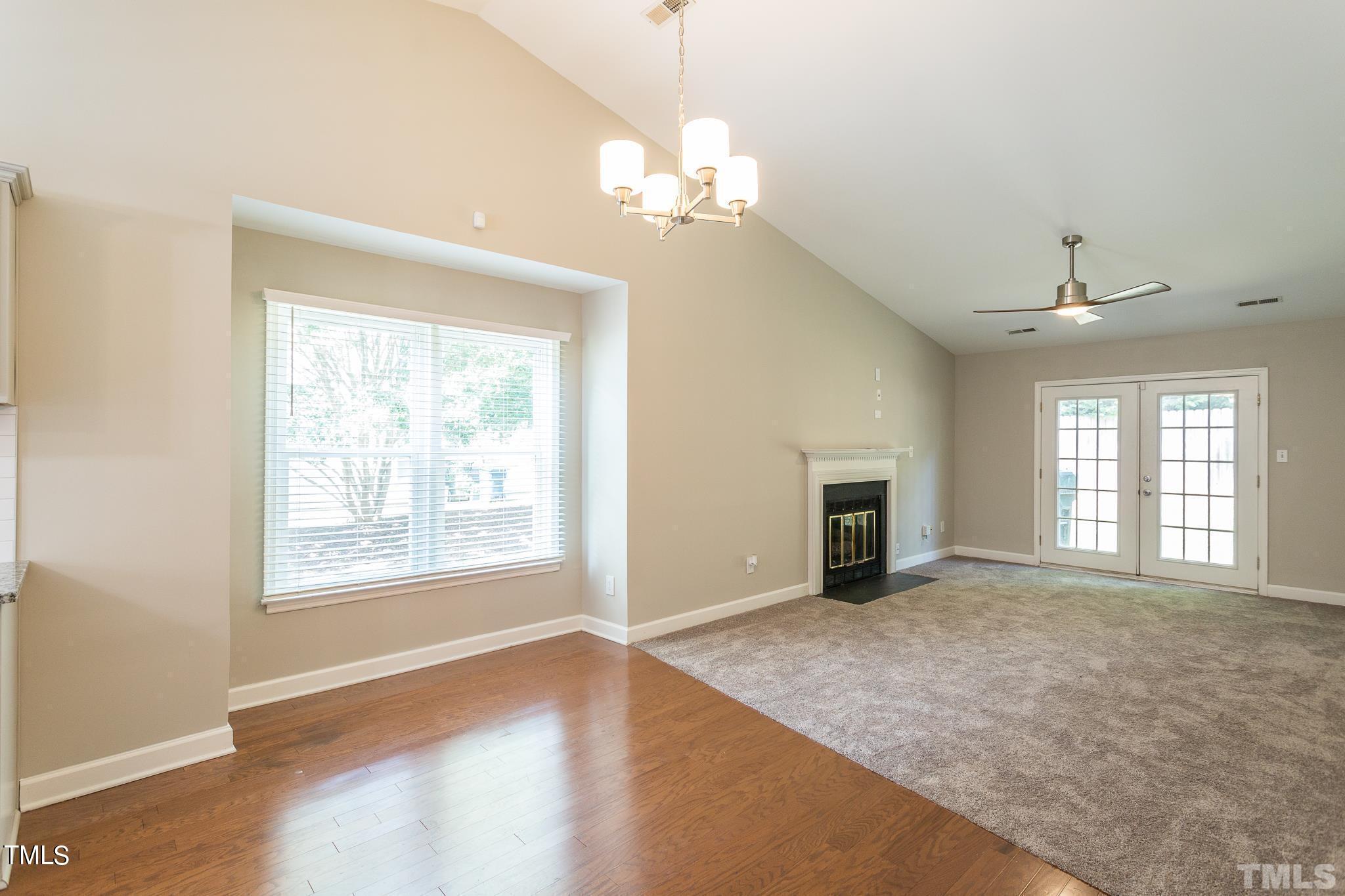 4424 Roller Court Raleigh, NC 27604 - Photo 10 of 19 a view of a livingroom with a chandelier fan and windows