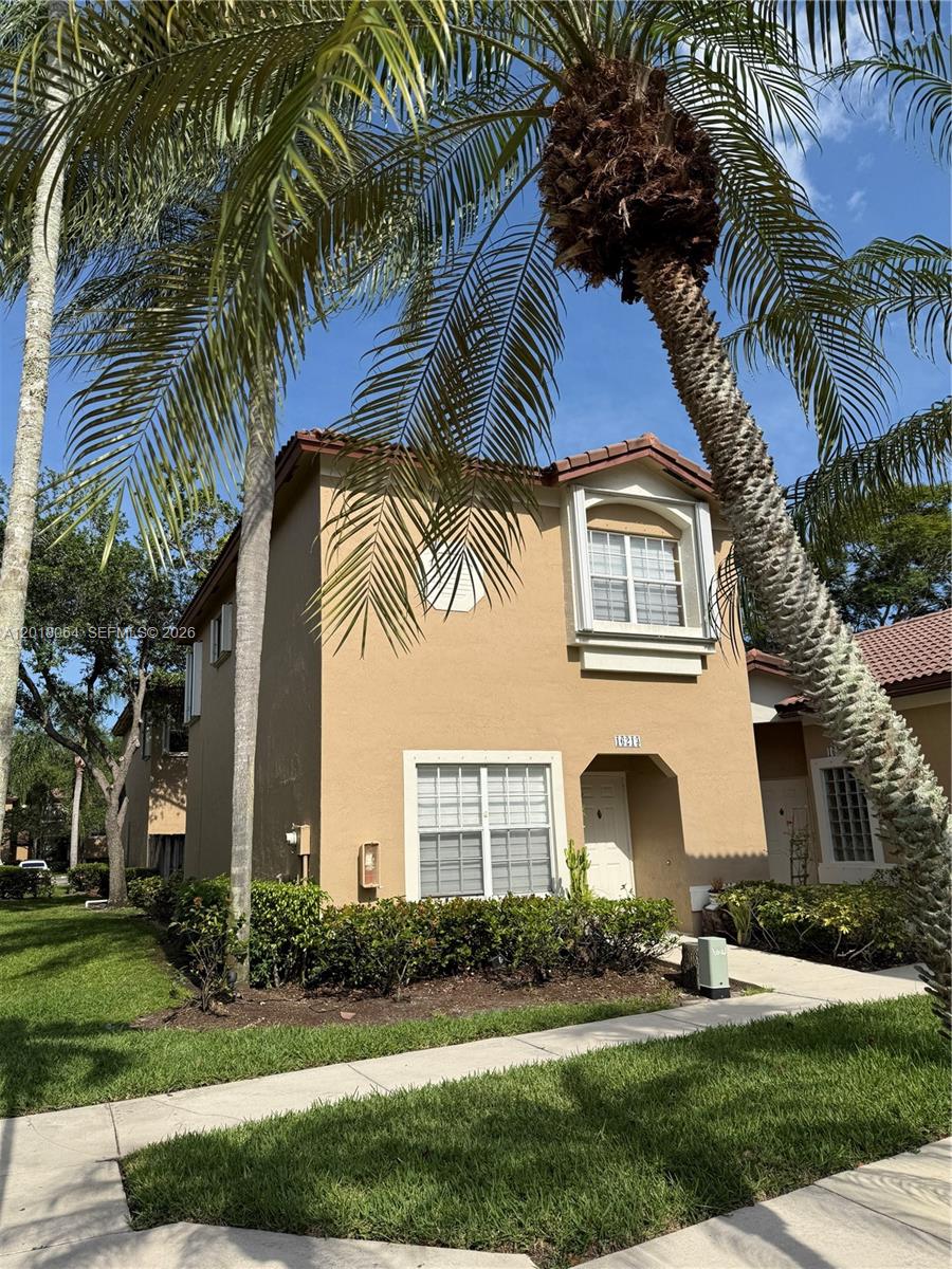 16213 Emerald Cove Road Weston, FL 33331 - Photo 18 of 27 a front view of multi story residential apartment building with yard and green space