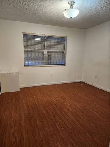 an empty room with wooden floor and closet