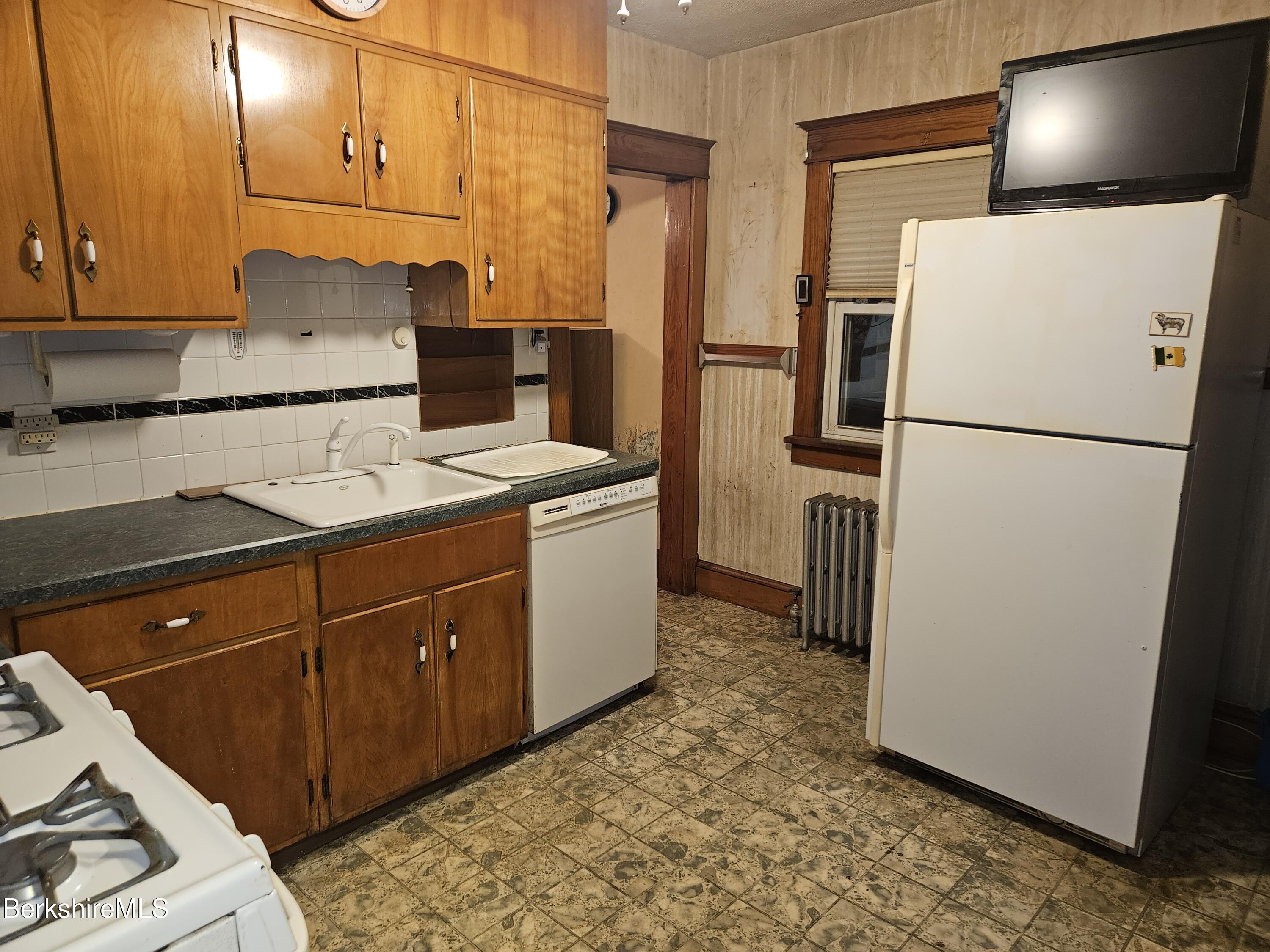 269 2nd Street Pittsfield, MA 01201 - Photo 16 of 39 a kitchen with a refrigerator and a stove