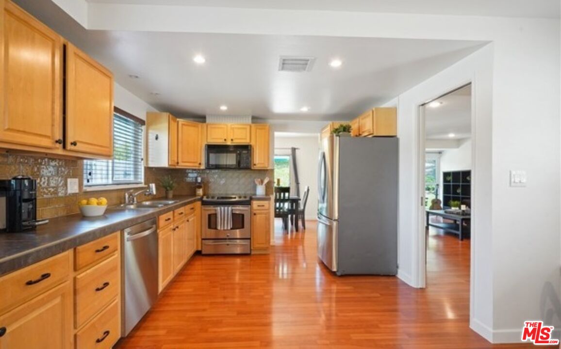 2590 Scott Place Thousand Oaks, CA 91360 - Photo 3 of 12 a kitchen with stainless steel appliances granite countertop a refrigerator and a stove top oven