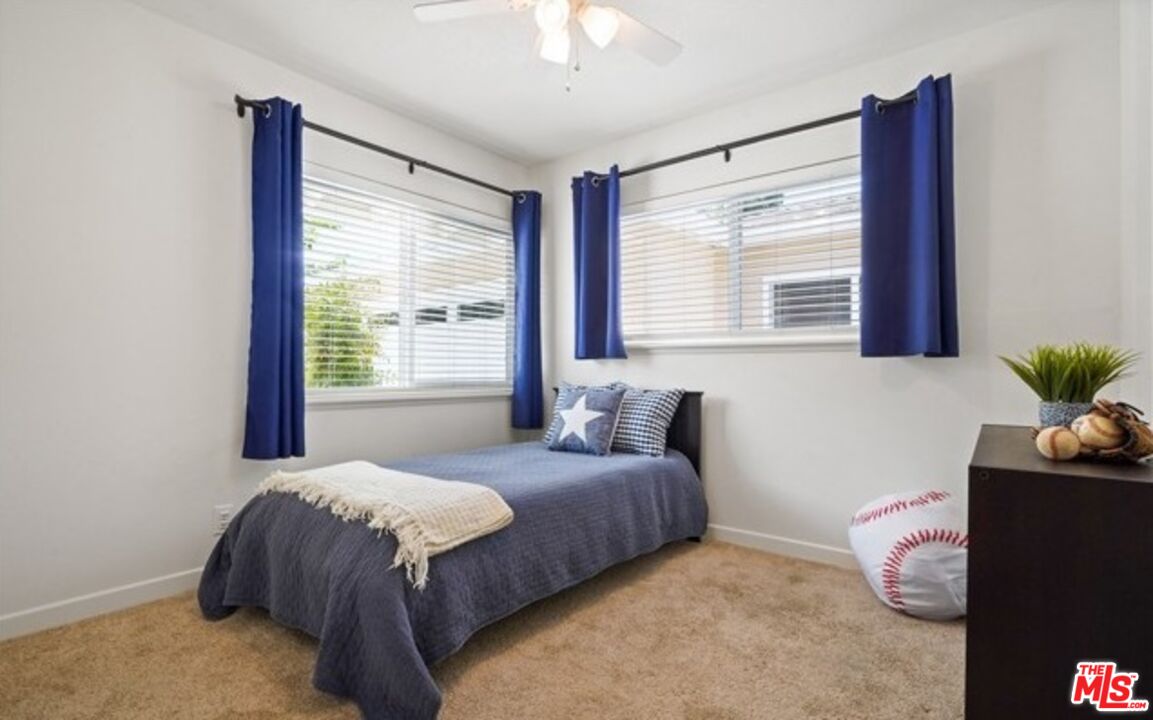 2590 Scott Place Thousand Oaks, CA 91360 - Photo 6 of 12 a bedroom with a bed and a potted plant next to a window