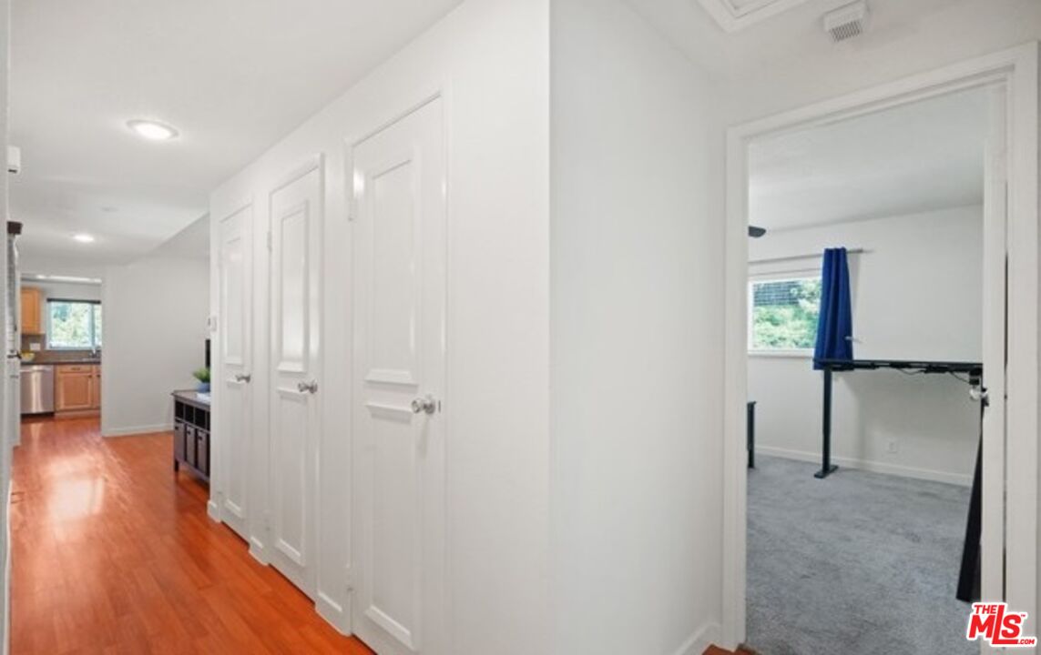 2590 Scott Place Thousand Oaks, CA 91360 - Photo 9 of 12 a view of a hallway with wooden floor and closet