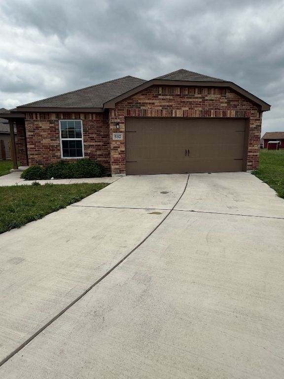 532 Fox Glen Trail Jarrell, TX 76537 - Photo 1 of 1 front view of a brick house with a large parking space