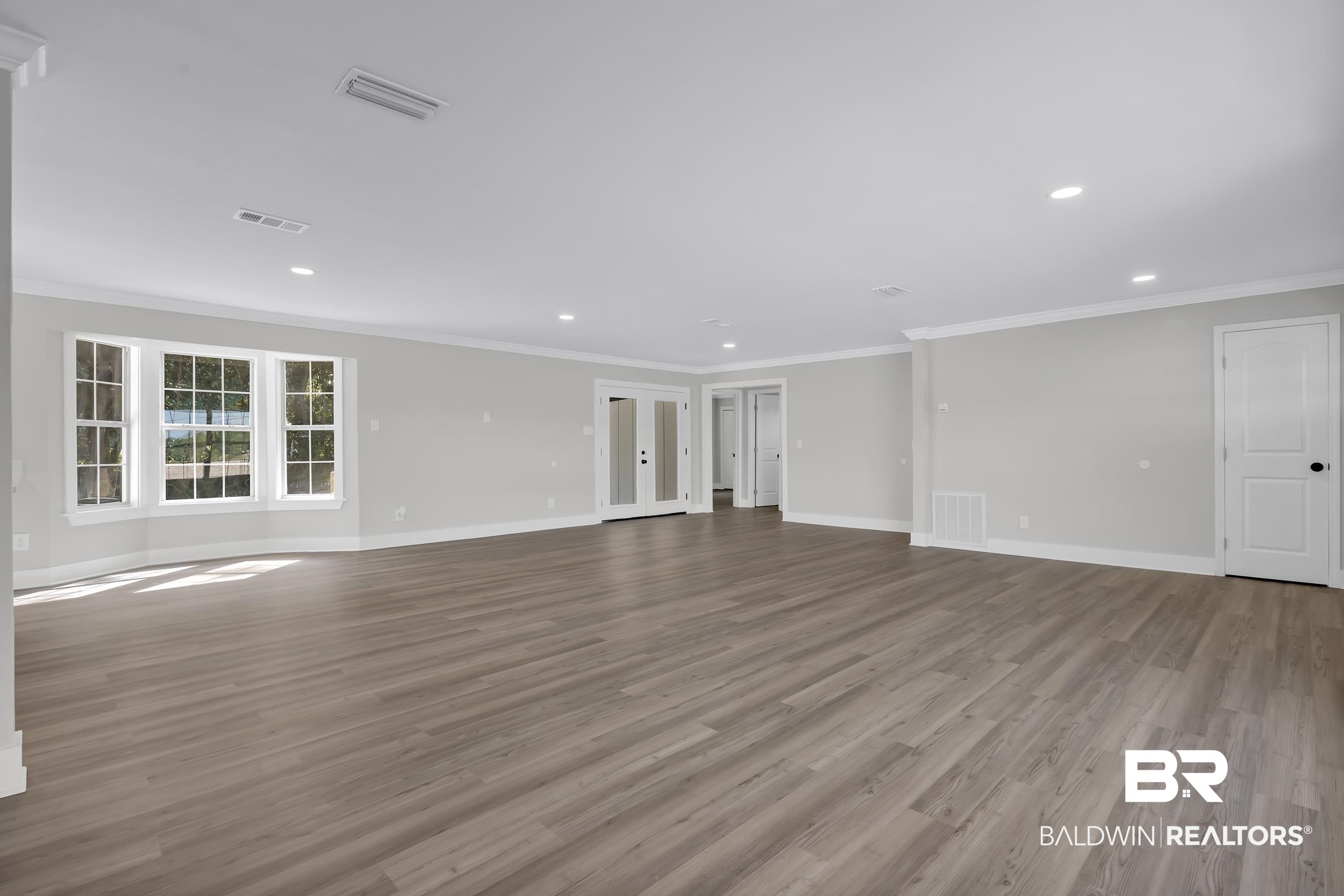 8351 Theodore Dawes Road Theodore, AL 36582 - Photo 8 of 46 Unfurnished living room featuring french doors, ornamental molding, light wood-type flooring, and recessed lighting
