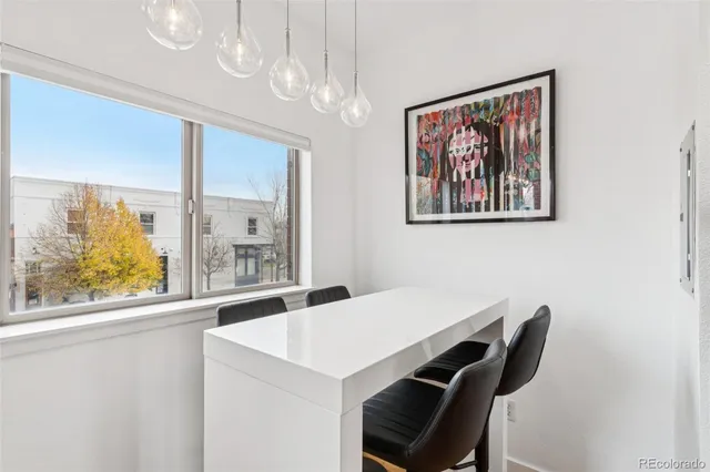 a view of a dining room with furniture and a large window