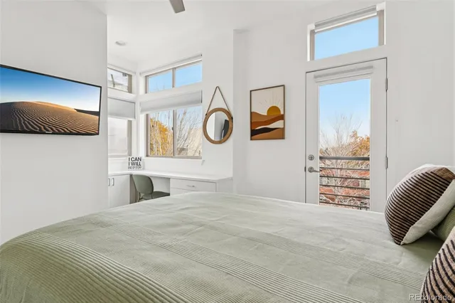 a bedroom with a bed and a painting on the wall