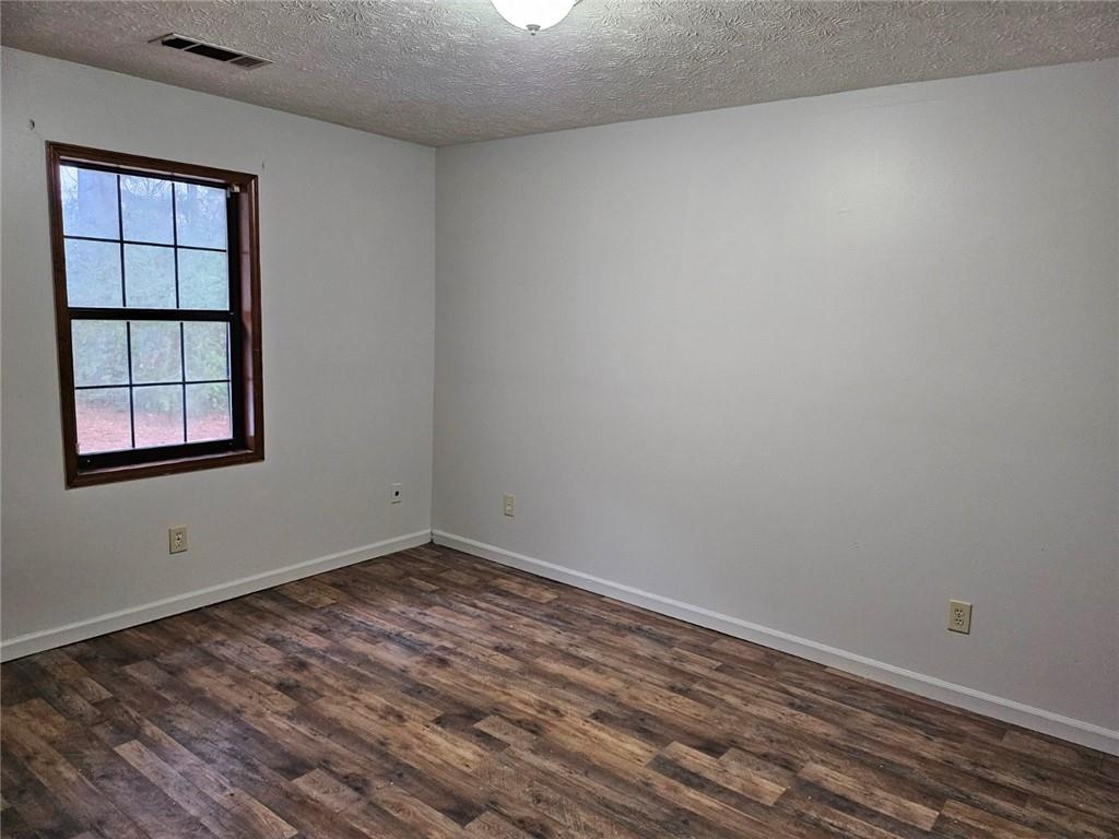 2835 Springdale Road, Unit B Snellville, GA 30039 - Photo 20 of 21 wooden floor in an empty room with a window