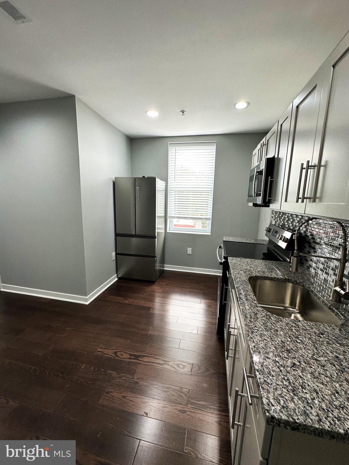 1801 West Venango Street, Unit 3 Philadelphia, PA 19140 - Photo 5 of 22 a kitchen with granite countertop a refrigerator and a sink