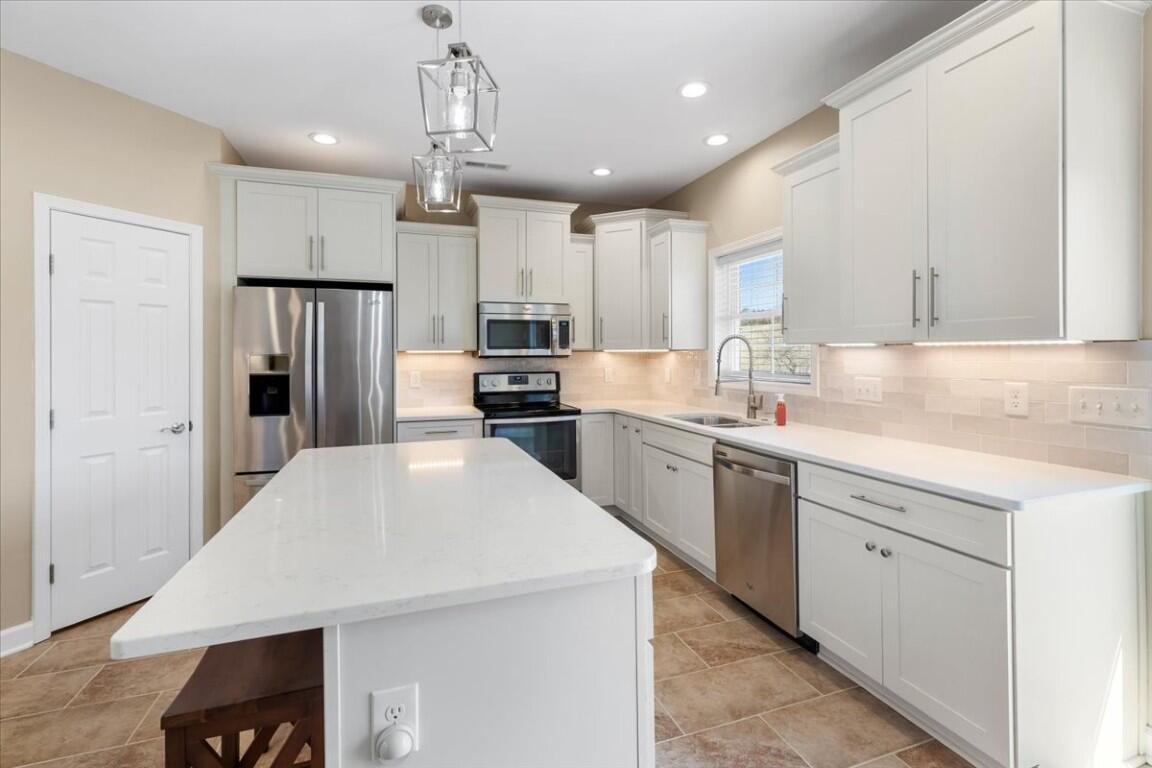 4030 Old Baltimore Road Draper, VA 24324 - Photo 19 of 105 a kitchen with kitchen island a sink stainless steel appliances and cabinets