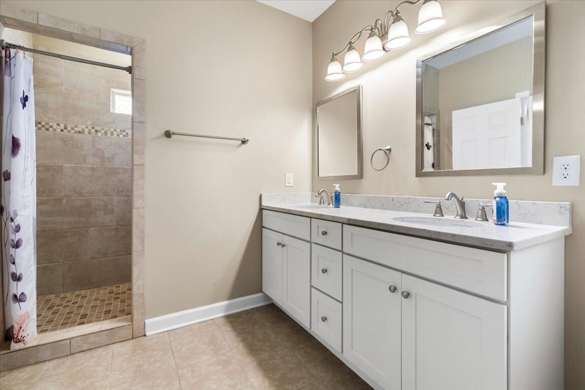 4030 Old Baltimore Road Draper, VA 24324 - Photo 33 of 105 a bathroom with double sink and a mirror