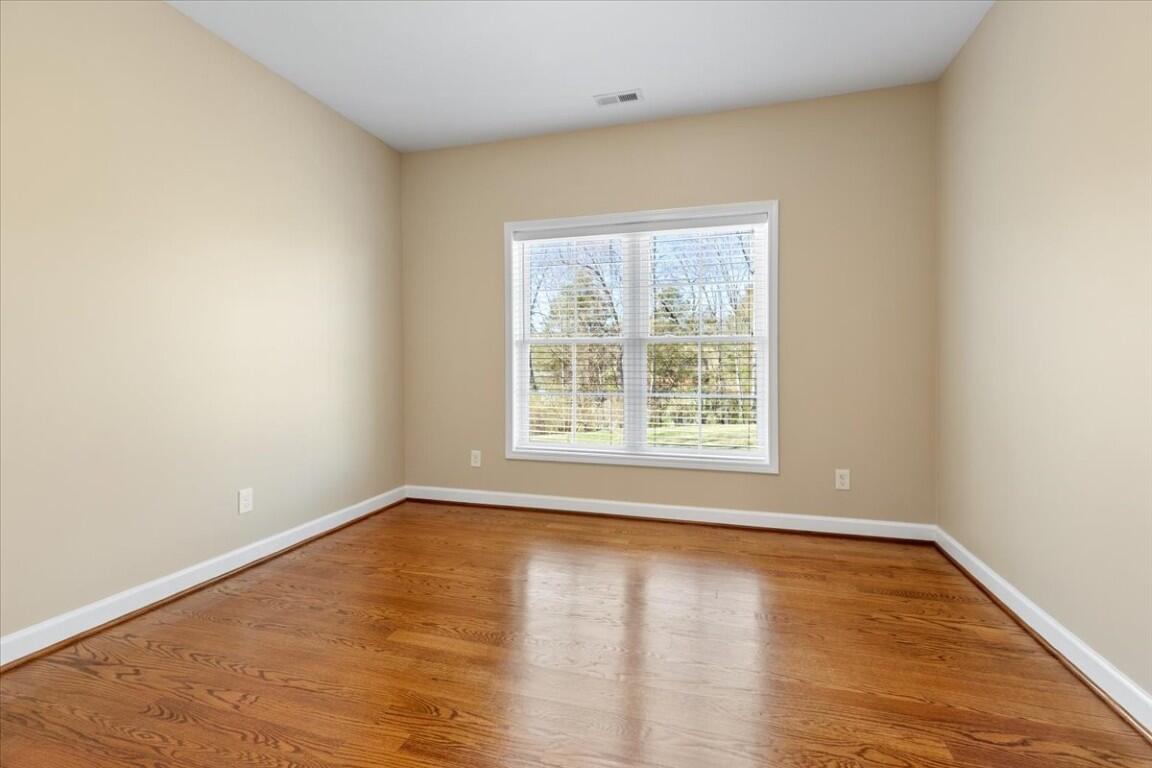 4030 Old Baltimore Road Draper, VA 24324 - Photo 39 of 105 an empty room with wooden floor and windows