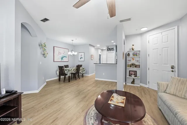 a living room with furniture and a wooden floor