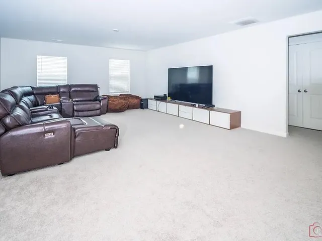 a bedroom with a bed next to a window