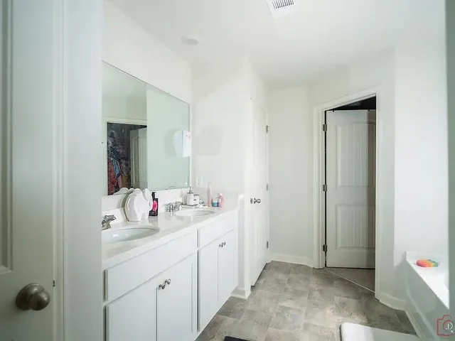a bathroom with a glass shower door