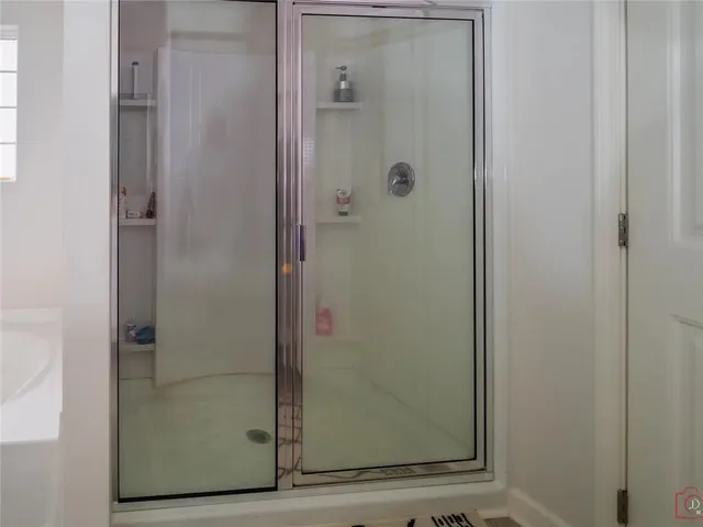 a bedroom with a bed and large window