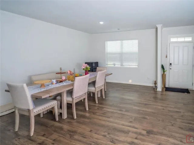 a dining room with furniture wooden floor and a rug