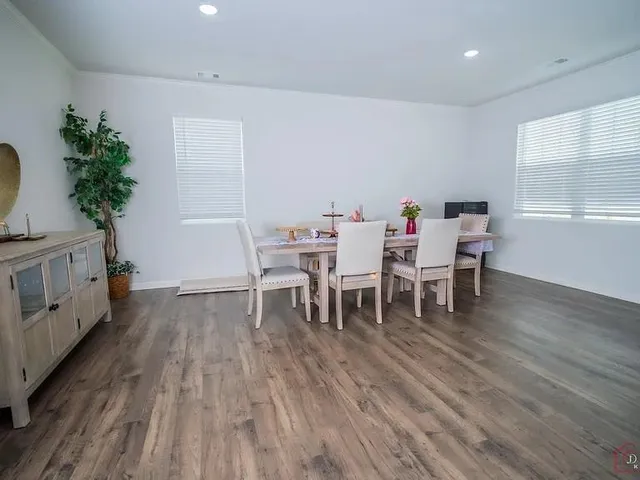 a dining room with furniture and wooden floor