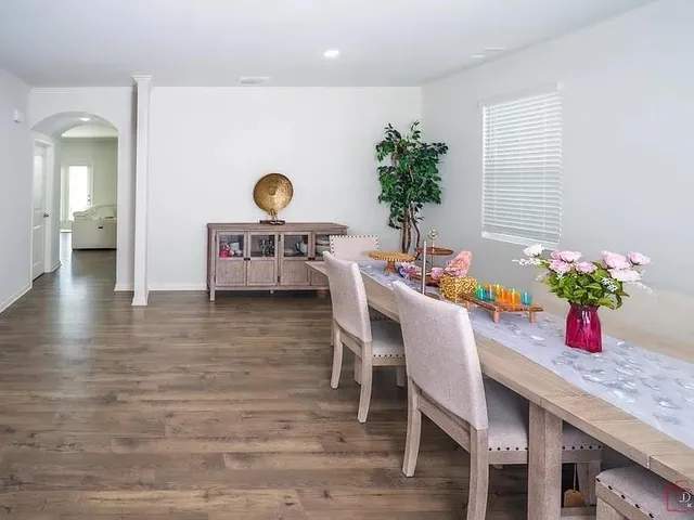 a view of a dining room with furniture and wooden floor