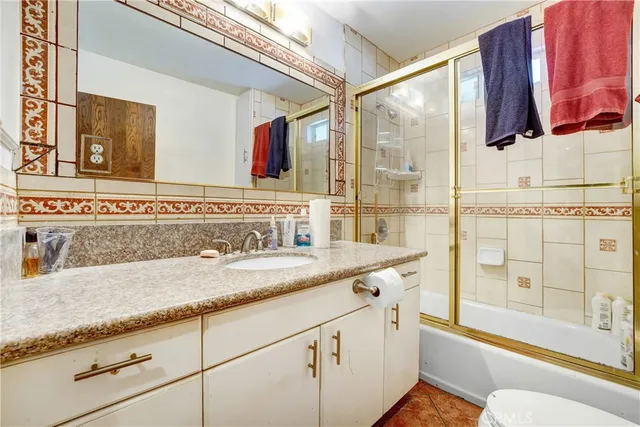 a bathroom with a shower and a glass door