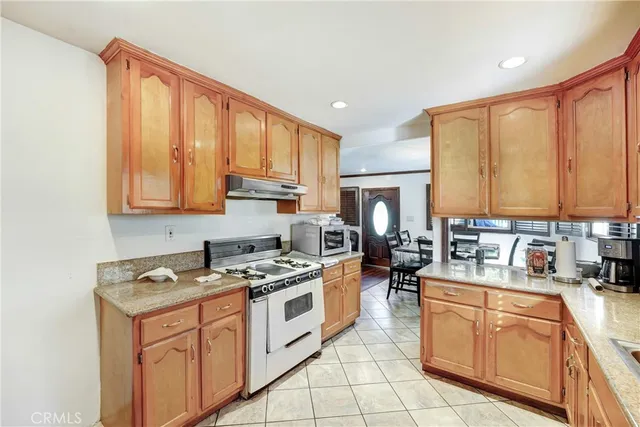 a dining room filled chandelier and wooden floor