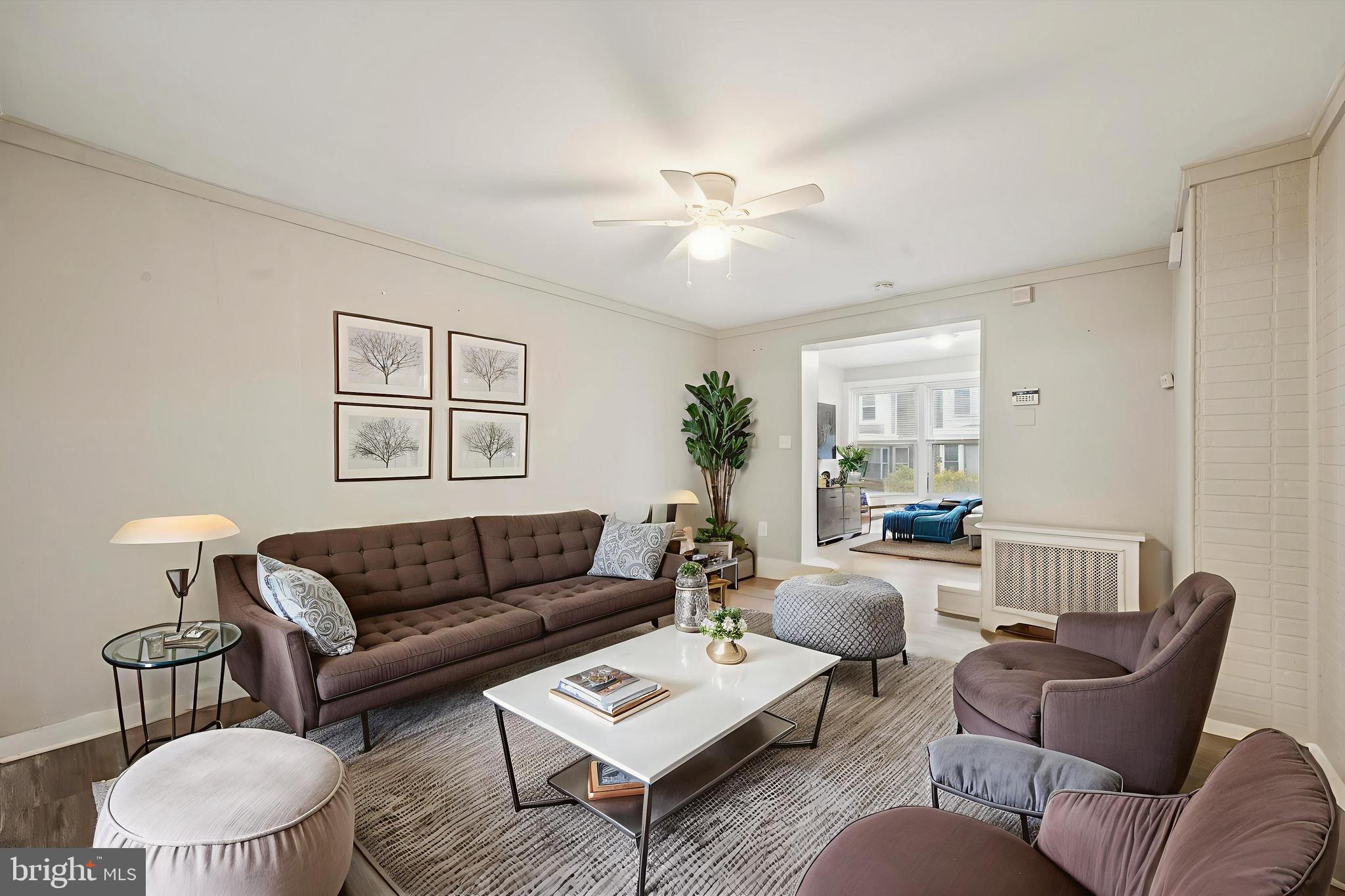 6619 Guyer Avenue, Unit 1 Philadelphia, PA 19142 - Photo 1 of 16 a living room with furniture a rug and a chandelier