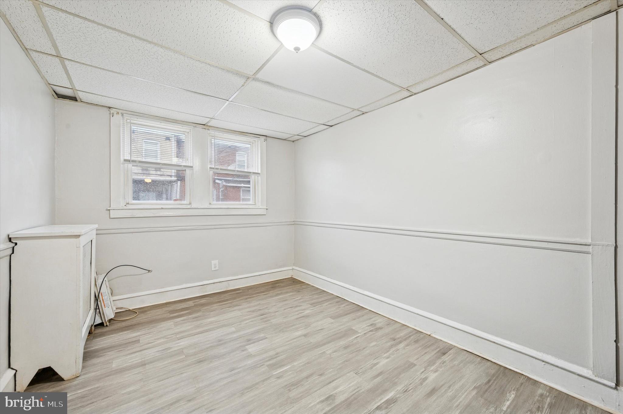6619 Guyer Avenue, Unit 1 Philadelphia, PA 19142 - Photo 6 of 16 a view of a room with wooden floor and cabinet