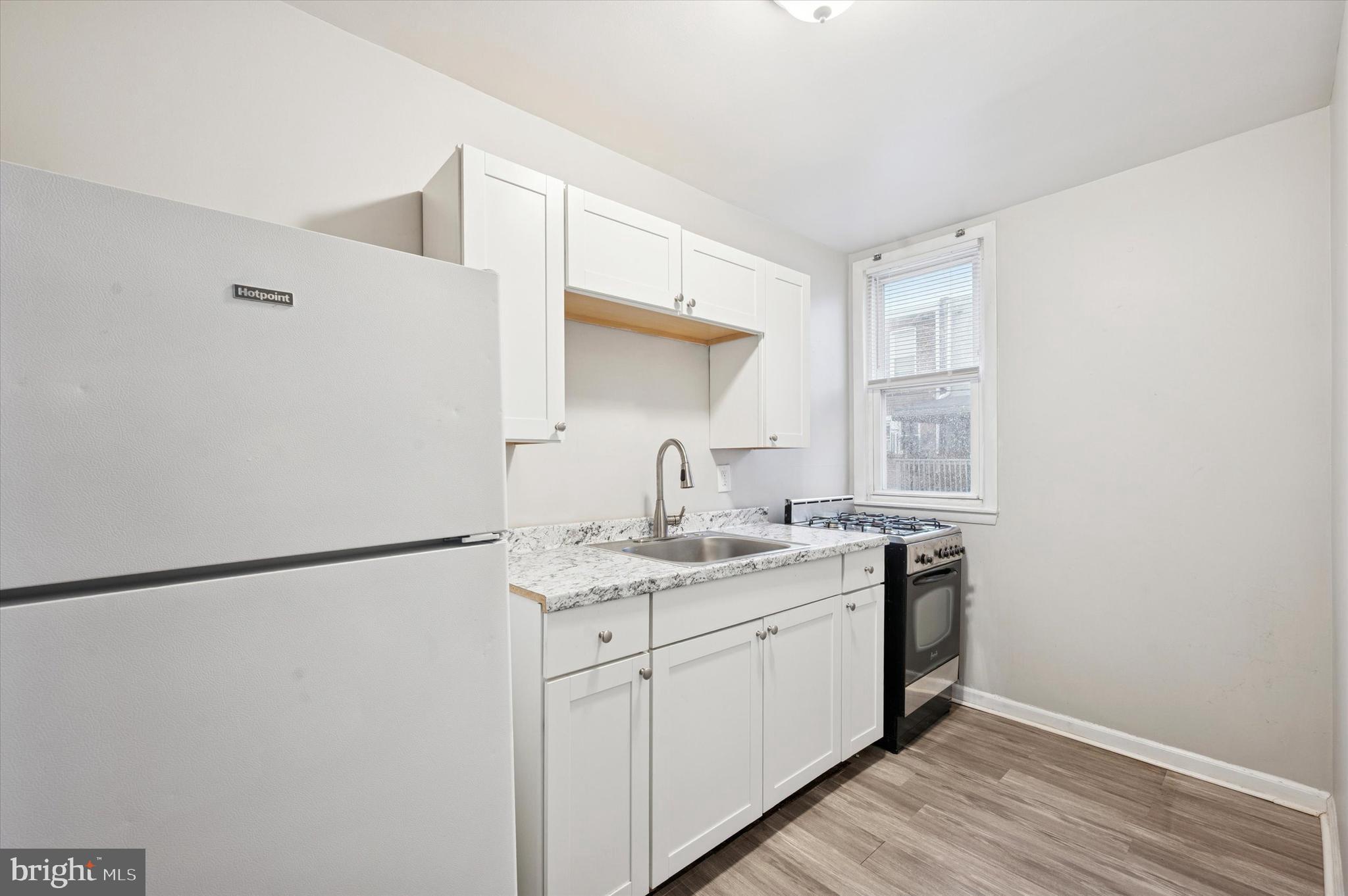 6619 Guyer Avenue, Unit 1 Philadelphia, PA 19142 - Photo 9 of 16 a kitchen with a sink and a refrigerator