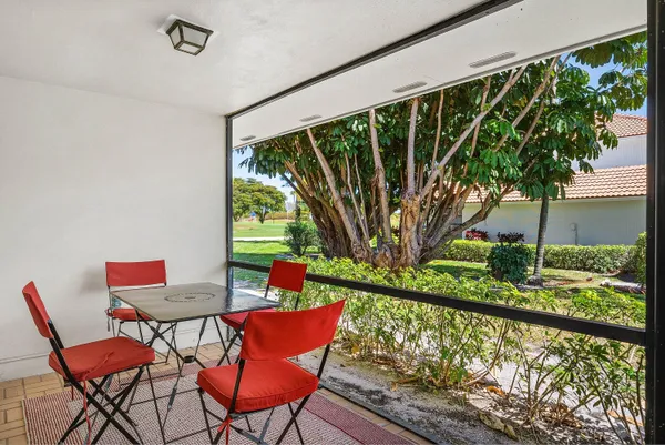 a roof deck with table and chairs and wooden floor