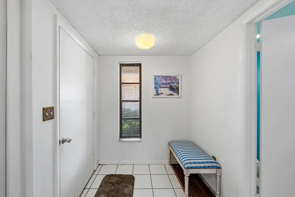 a view of room with a piano and wooden floor