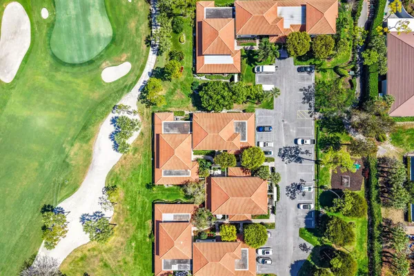 an aerial view of a house with a garden and trees
