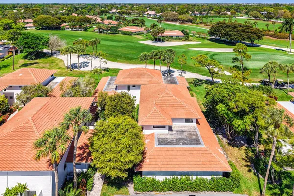 an aerial view of a house with a yard basket ball court and outdoor seating