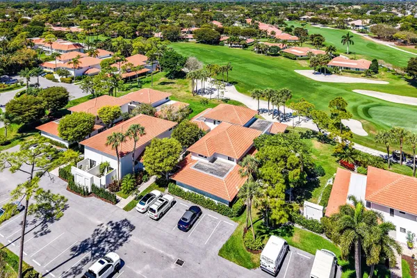 an aerial view of residential houses with outdoor space and street view