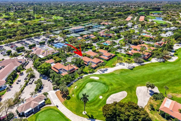 an aerial view of residential houses with outdoor space and trees
