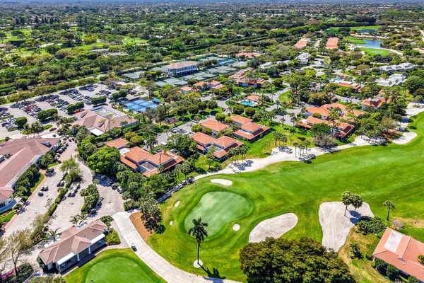 an aerial view of residential houses with outdoor space and trees