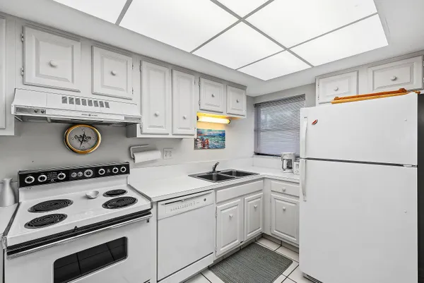 a kitchen with a refrigerator and a stove