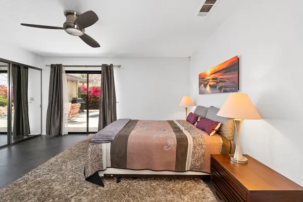 a bedroom with a bed and a painting on the wall