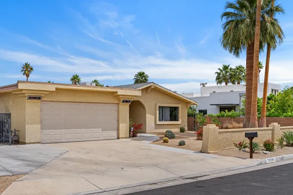 a view of a house with a backyard and a garage