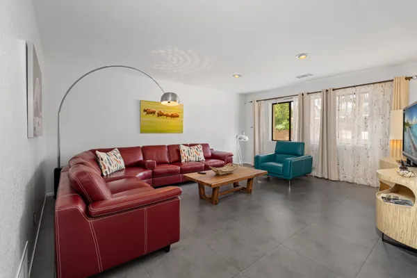a living room with furniture and a large window