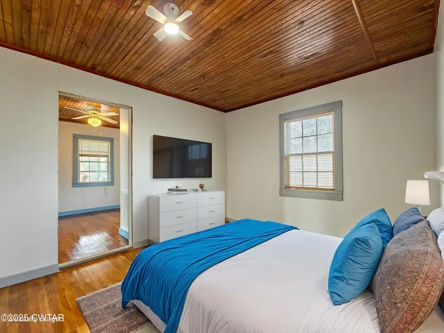 a bedroom with a bed and a flat screen tv