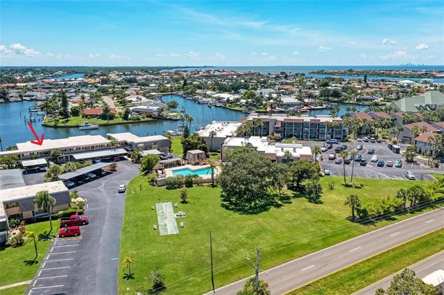 an aerial view of a house with swimming pool patio and lake view