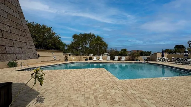 a view of a swimming pool with lounge chairs