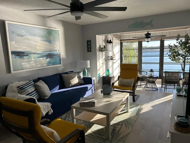 a living room with furniture a lamp and a rug