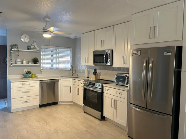 a kitchen with a refrigerator stove and microwave