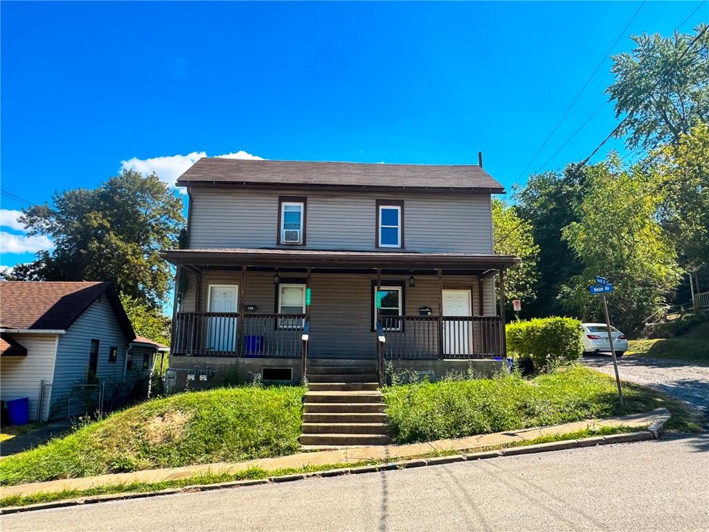 a front view of a house with a garden