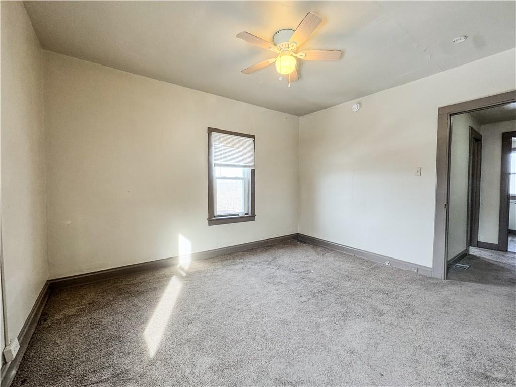 119 Heim Avenue Butler, PA 16001 - Photo 8 of 10 an empty room with windows and chandelier fan