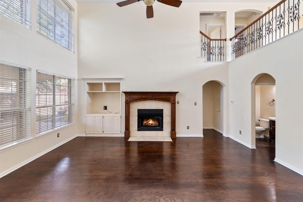 2021 Country Brook Lane Allen, TX 75002 - Photo 11 of 40 a view of an empty room with exposed radiator and fireplace