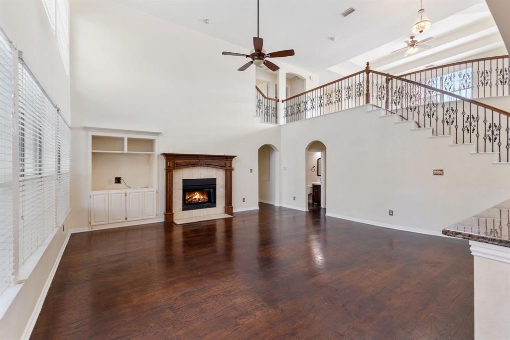 2021 Country Brook Lane Allen, TX 75002 - Photo 12 of 40 a view of a livingroom with wooden floor and a fireplace